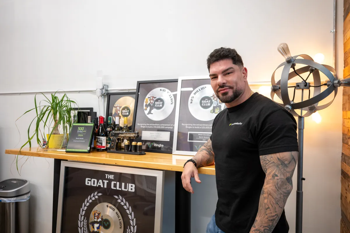 Manny Zuccarelli with his collection of Ringba GOAT Club awards at Quote Velocity