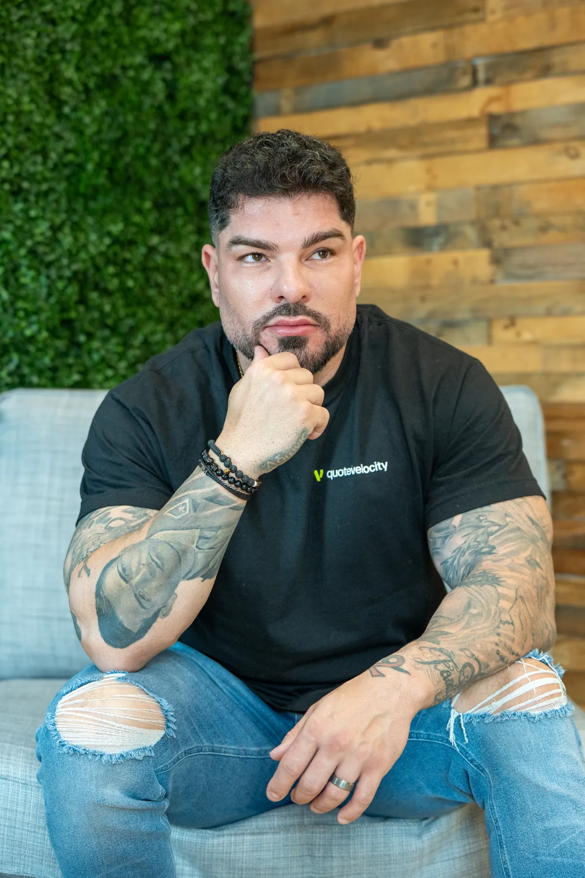 Manny Zuccarelli seated in the Quote Velocity office